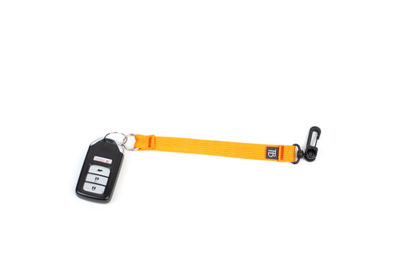 An 8-inch Zest (orange) Key Strap with a snaphook at one end and a split-ring o-ring at the other.